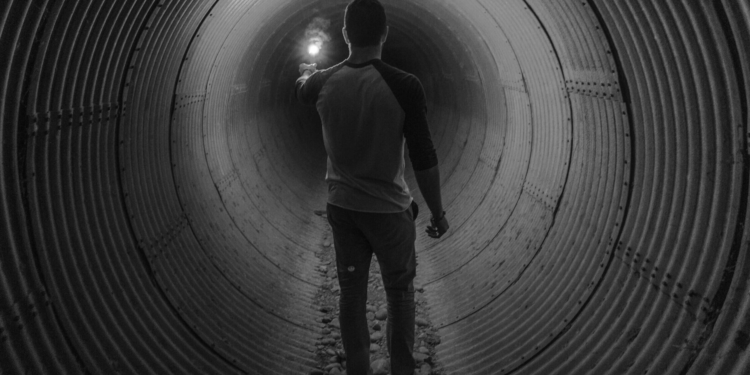 Guy walking in tunnel